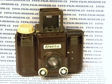 Bakelitový fotoaparát na svitkový film. Výroba od r. 1957. Produkuje negativy 6x6cm. Clona 8-22. 3 časy + B. Rámový hledáček. Objektiv typu Achromat. Fix focus. Ostrý od 3m do nekonečna. Natažení závěrky spojené s posunem filmu. Má kontakt pro blesk.